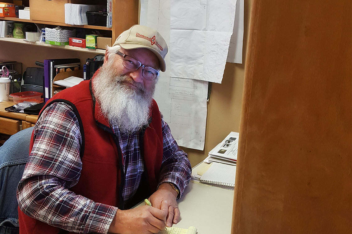 Man with White Beard writing on paper